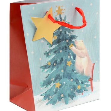 Gift bag with a Christmas tree and bear design on a light blue background