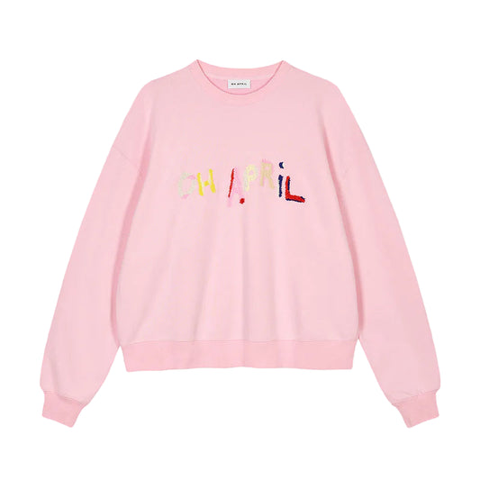 Pink sweatshirt with colorful text on a gray background
