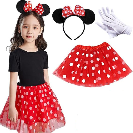Child wearing a red polka dot outfit with ears and headband, gloves, and accessories.