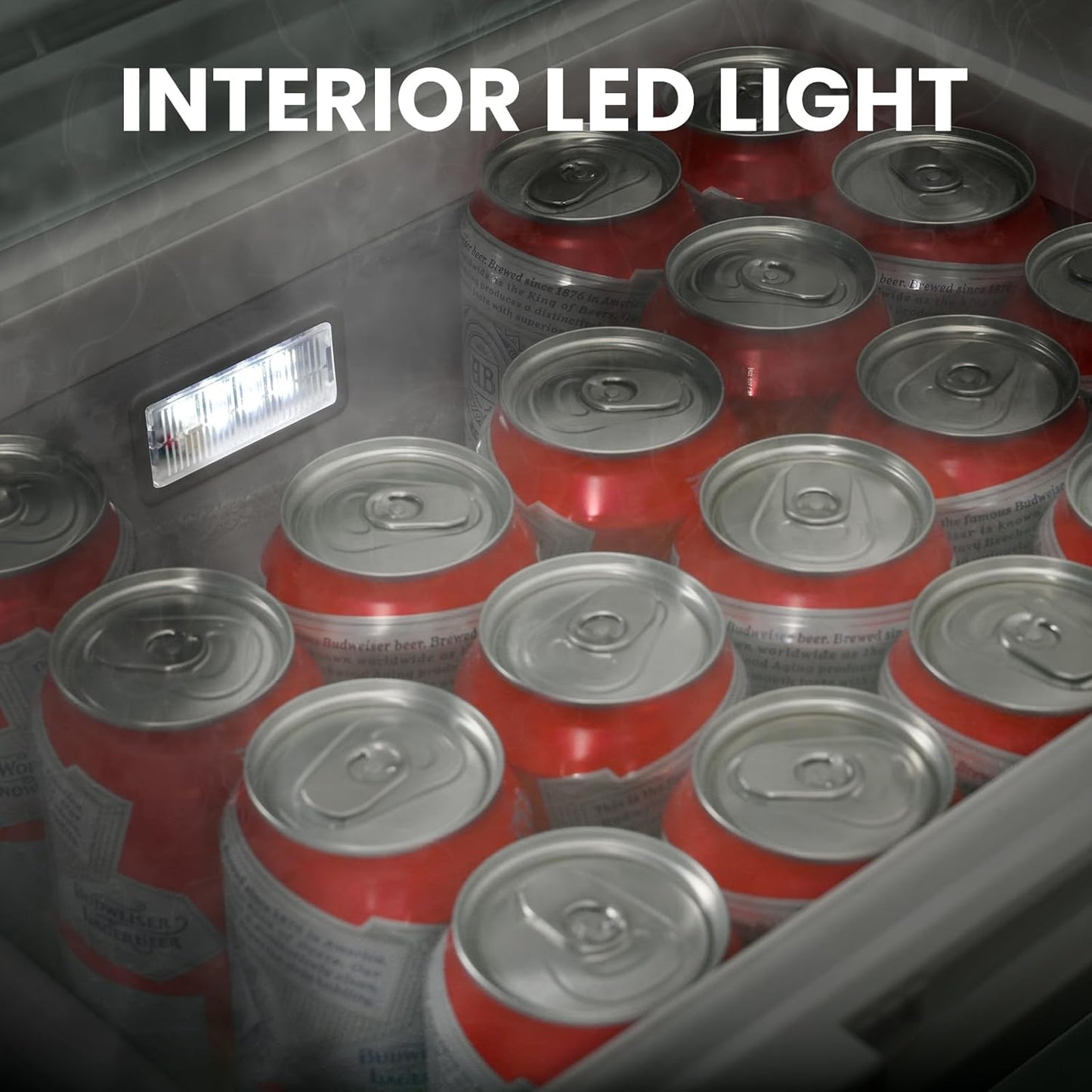 Red and silver beer cans in a cooler with an interior LED light visible.