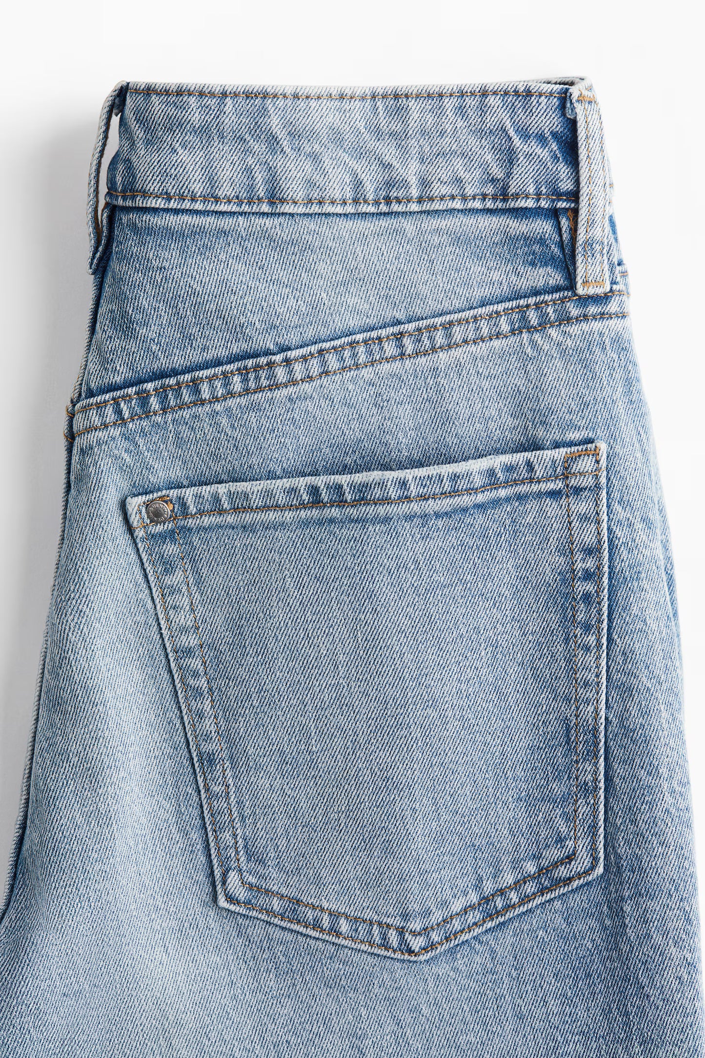 Close-up of a blue denim skirt on a white background
