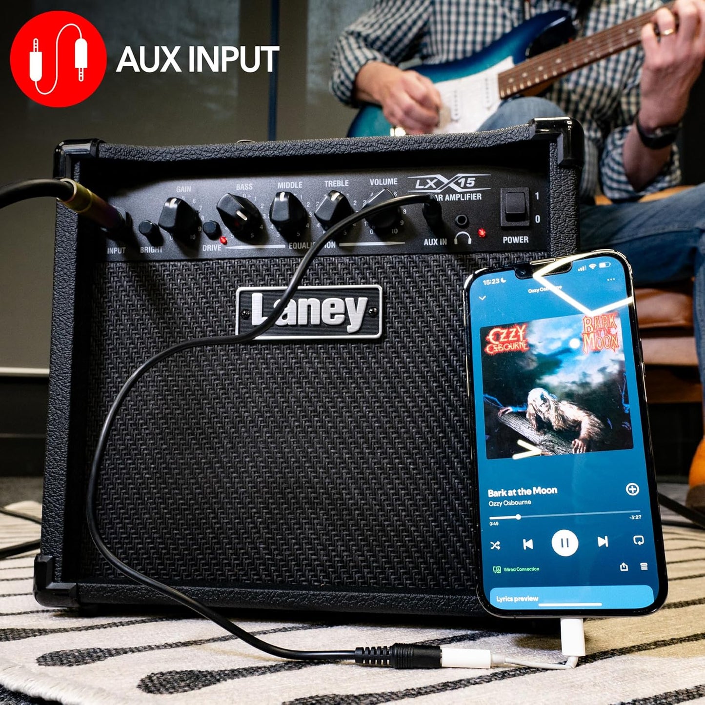 Laney guitar amplifier with smartphone displaying music app and Aux input icon.