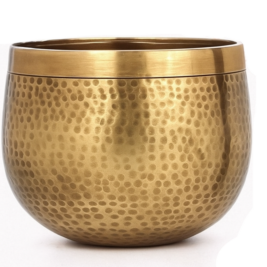 Gold metal pot with textured surface on a white background