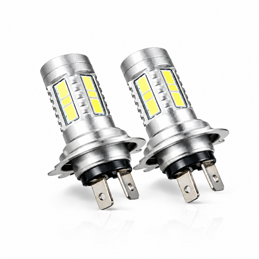 Two LED car bulbs in front of their packaging box on a white background