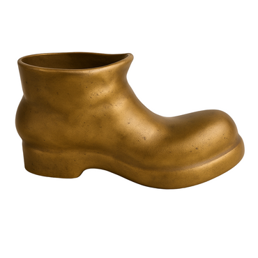 Bronze boot-shaped vase on a beige background