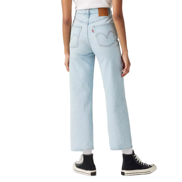 Light blue jeans worn by a person on a white background