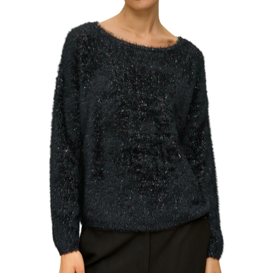 Person wearing a dark blue textured sweater on a white background