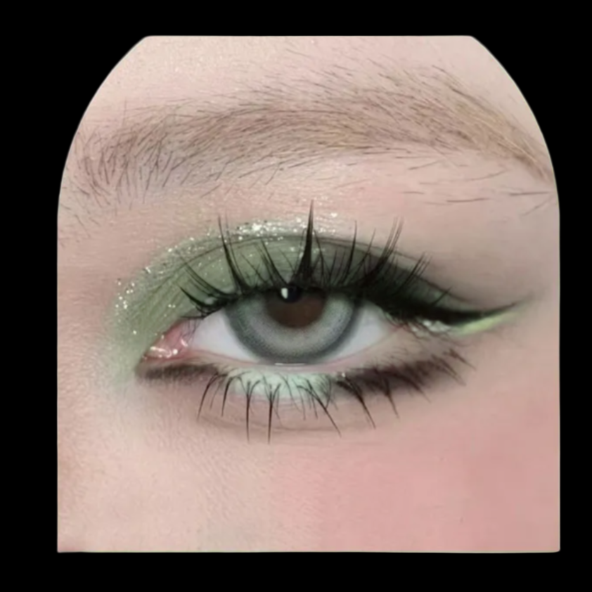 Close-up of an eye with green eyeshadow and long eyelashes on a pink background