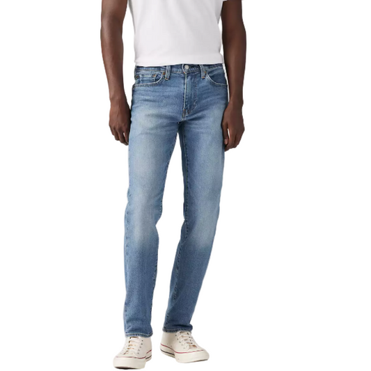 Person wearing a white t-shirt and light blue jeans on a plain background