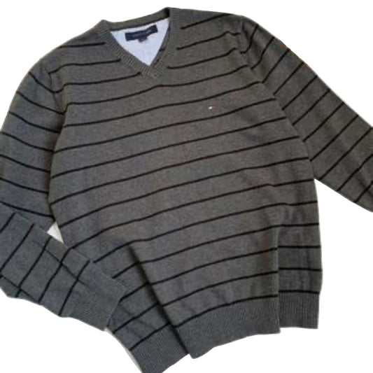 Gray striped sweater on a white surface with a phone interface overlay.