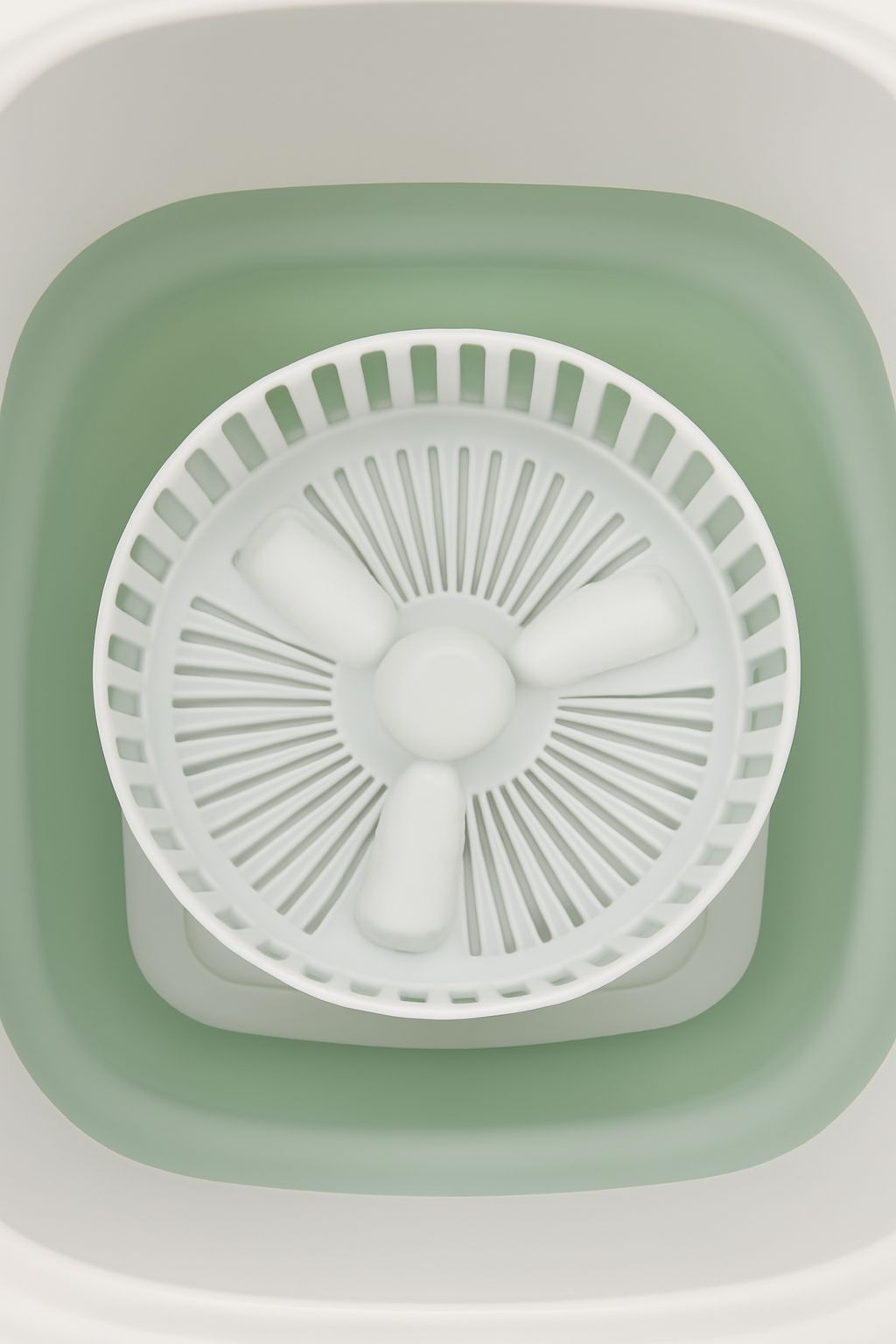 inside of a mini portable washing machine on white background