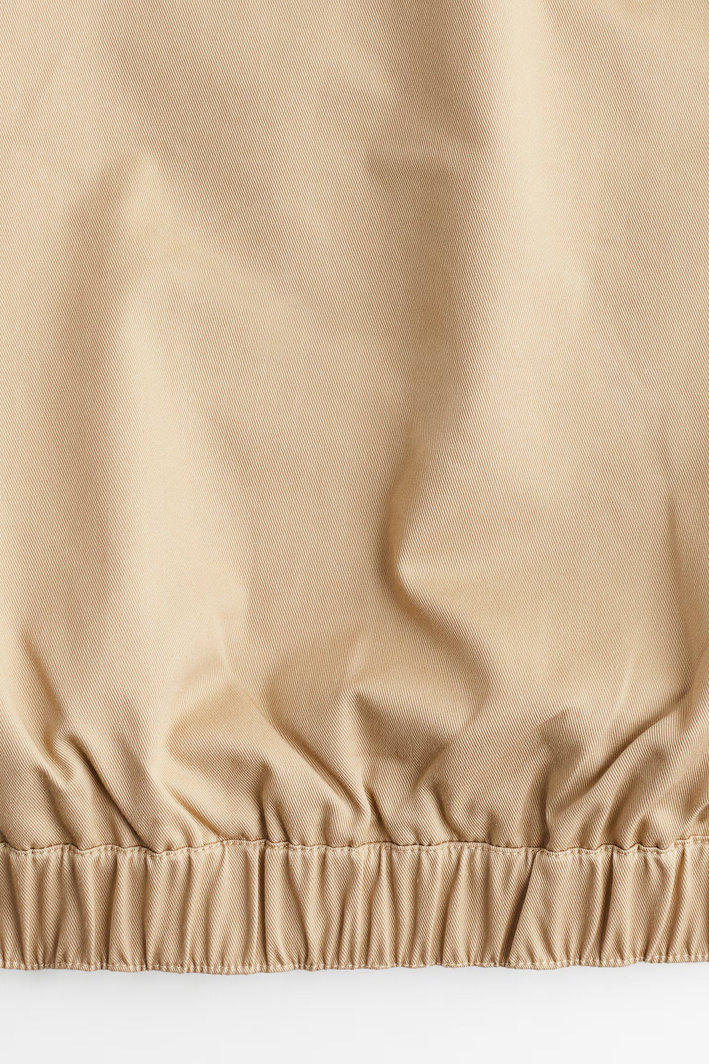 Close-up of beige fabric with a textured surface