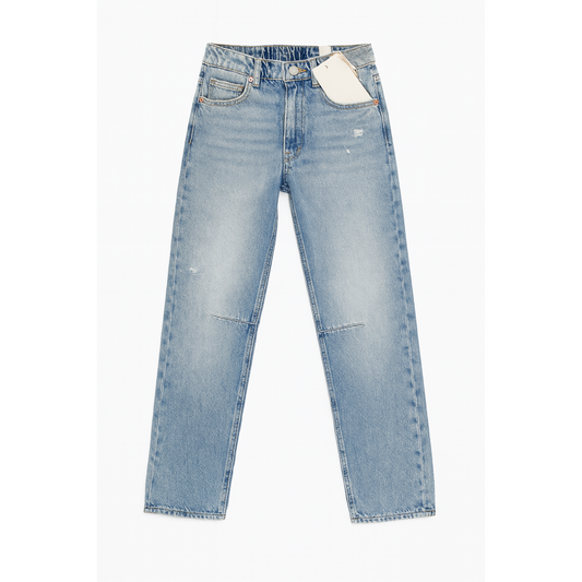 Light blue jeans with a tag on a white background