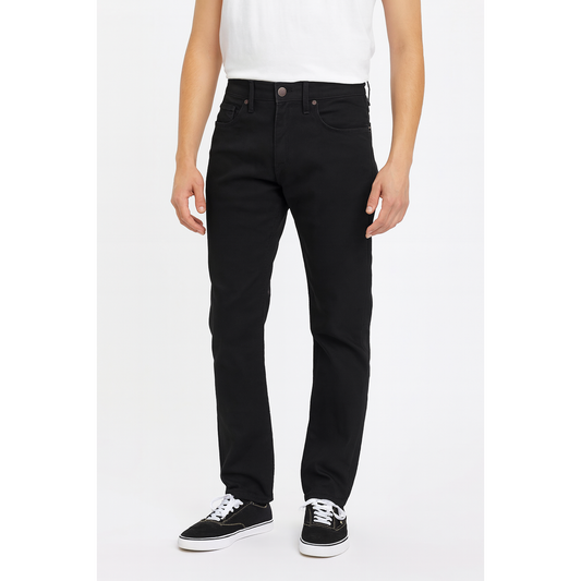 Person wearing black jeans and white sneakers on a white background