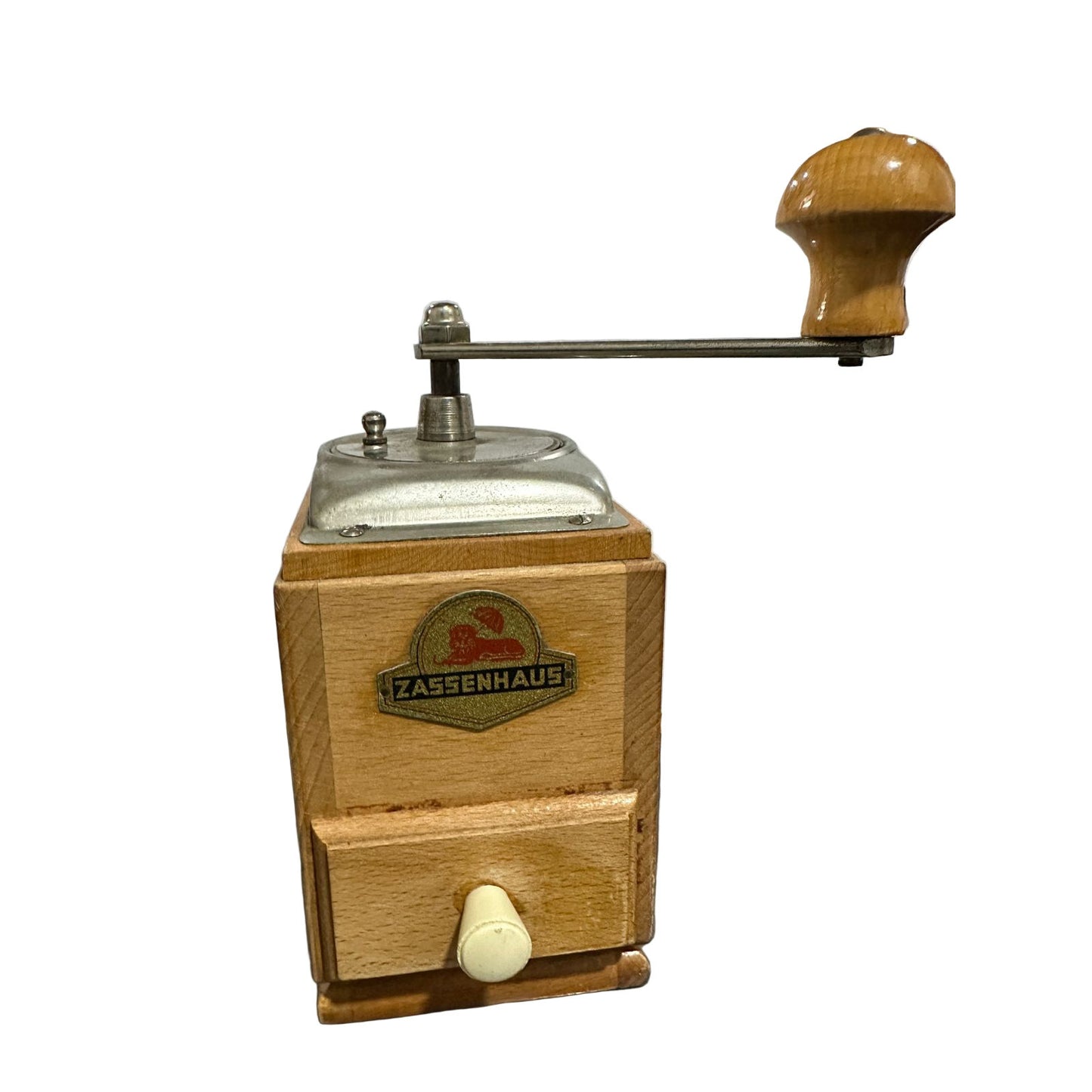 Wooden coffee grinder with Zassenhaus logo on a reflective surface