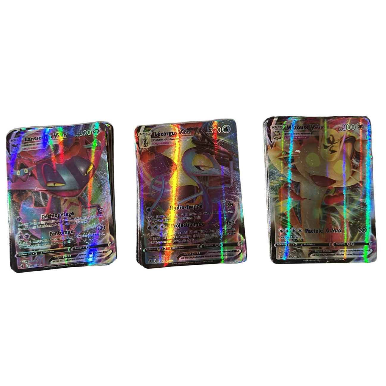 Three colorful trading cards on a reflective surface with a blurred background