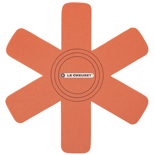 Orange silicone mat with 'Le Creuset' logo on a white background