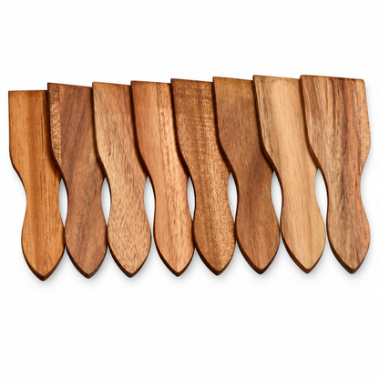 Eight wooden serving spoons with curved handles and flat broad heads, arranged in a row against a plain white background.
