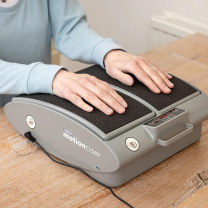Person using a motion ciser device on a wooden surface