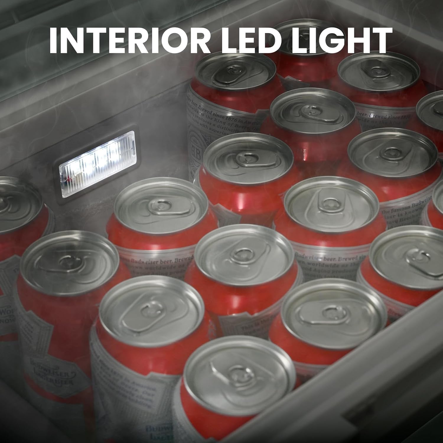 Red and silver beer cans in a cooler with an interior LED light visible.
