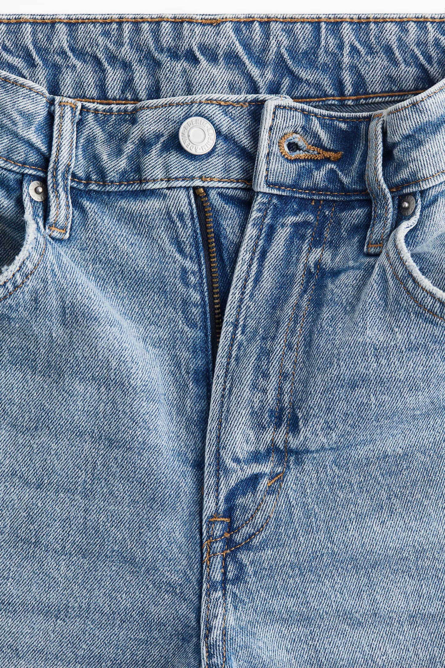 Close-up of a blue denim fabric with stitching details