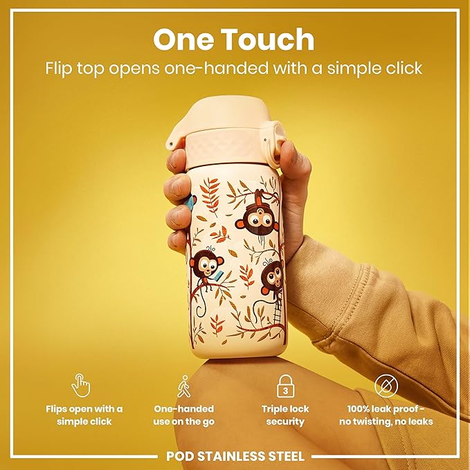 Hand holding a stainless steel water bottle with monkey design on a yellow background