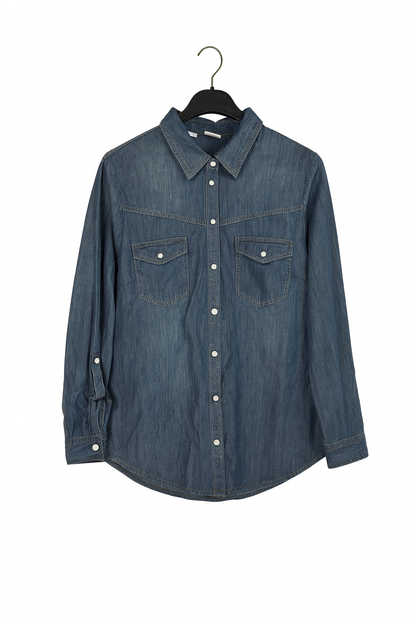 Blue denim shirt on a hanger against a white background