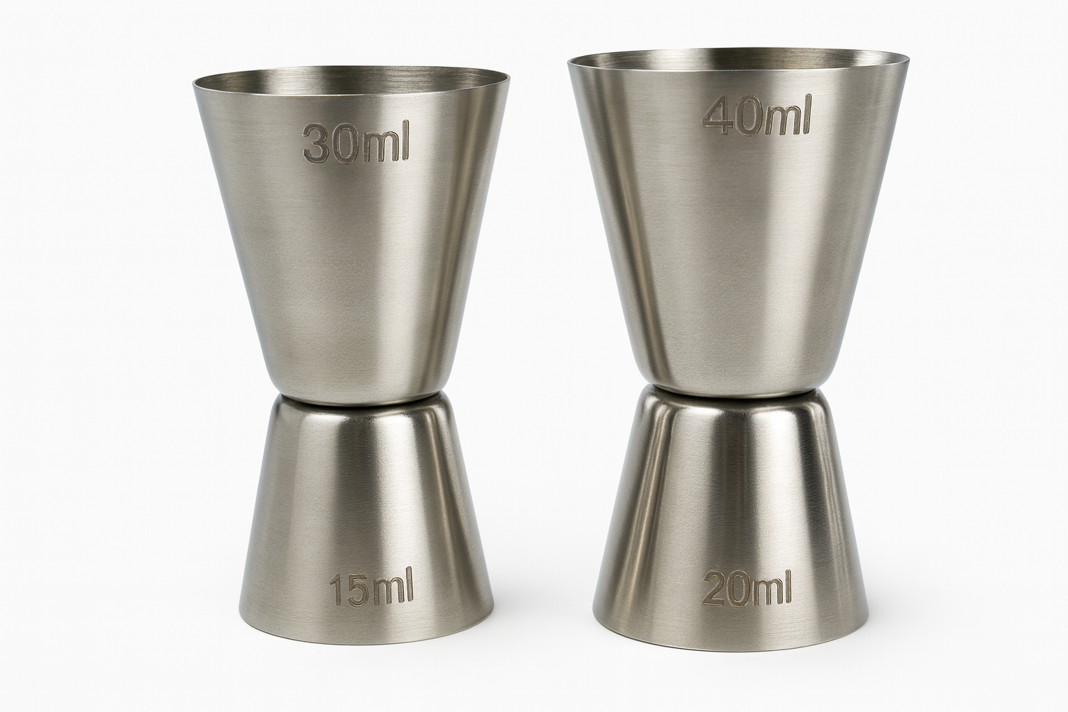 Two stainless steel jiggers with measurement markings on a white background