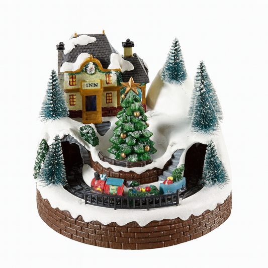 Christmas-themed miniature village with a house, tree, and cars on a snowy base.