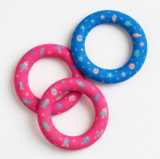 Two pink and one blue diving rings with cartoon designs on a white background