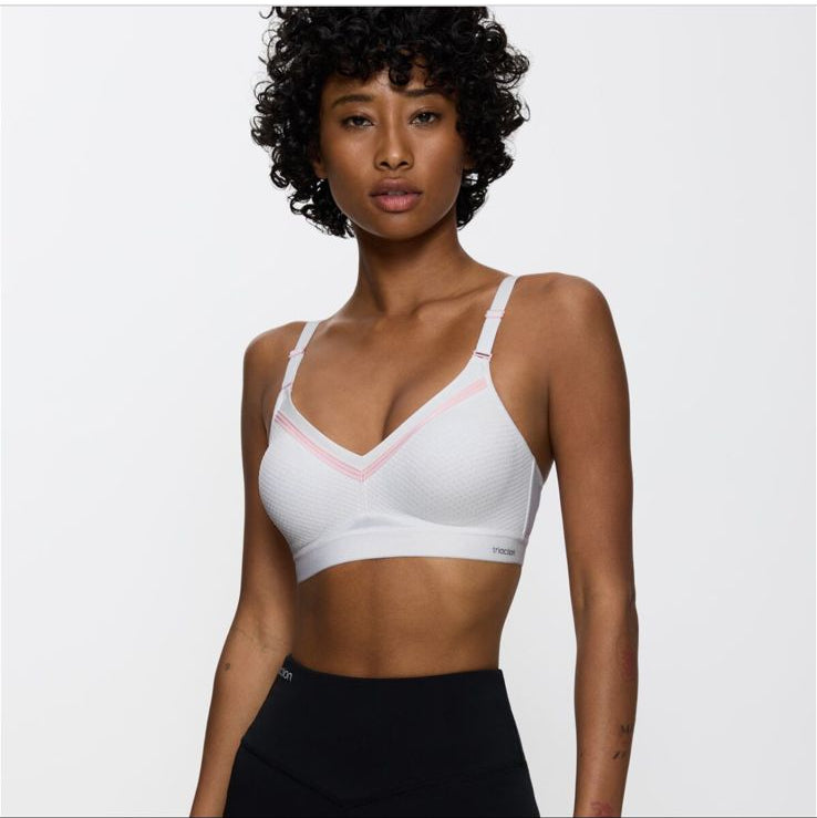 Woman wearing a white sports bra and black leggings on a website homepage.