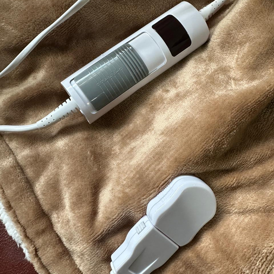 White electronic device with a cable on a brown textured surface