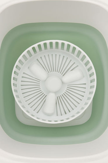 inside of a mini portable washing machine on white background