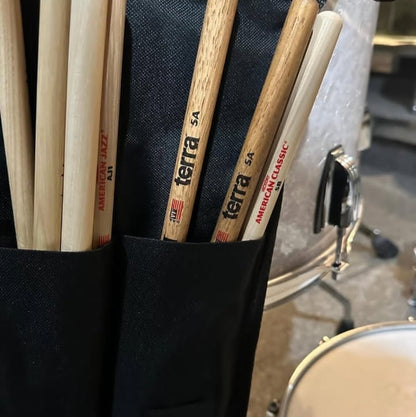 Close-up of drumsticks in a Vic Firth holder with a drum in the background