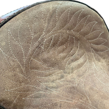 Close-up of a brown leather saddle with intricate stitching