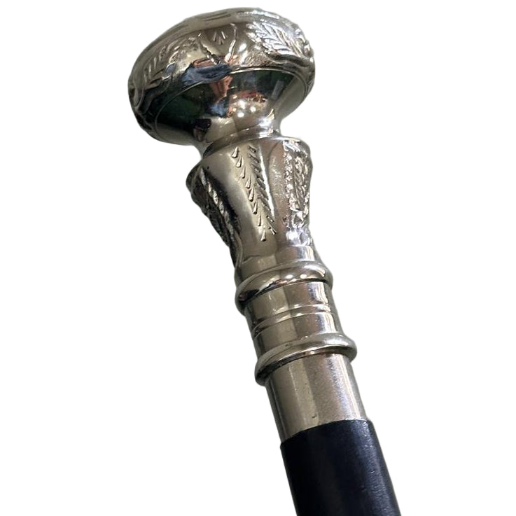 Silver-handled walking cane with black shaft against a white background