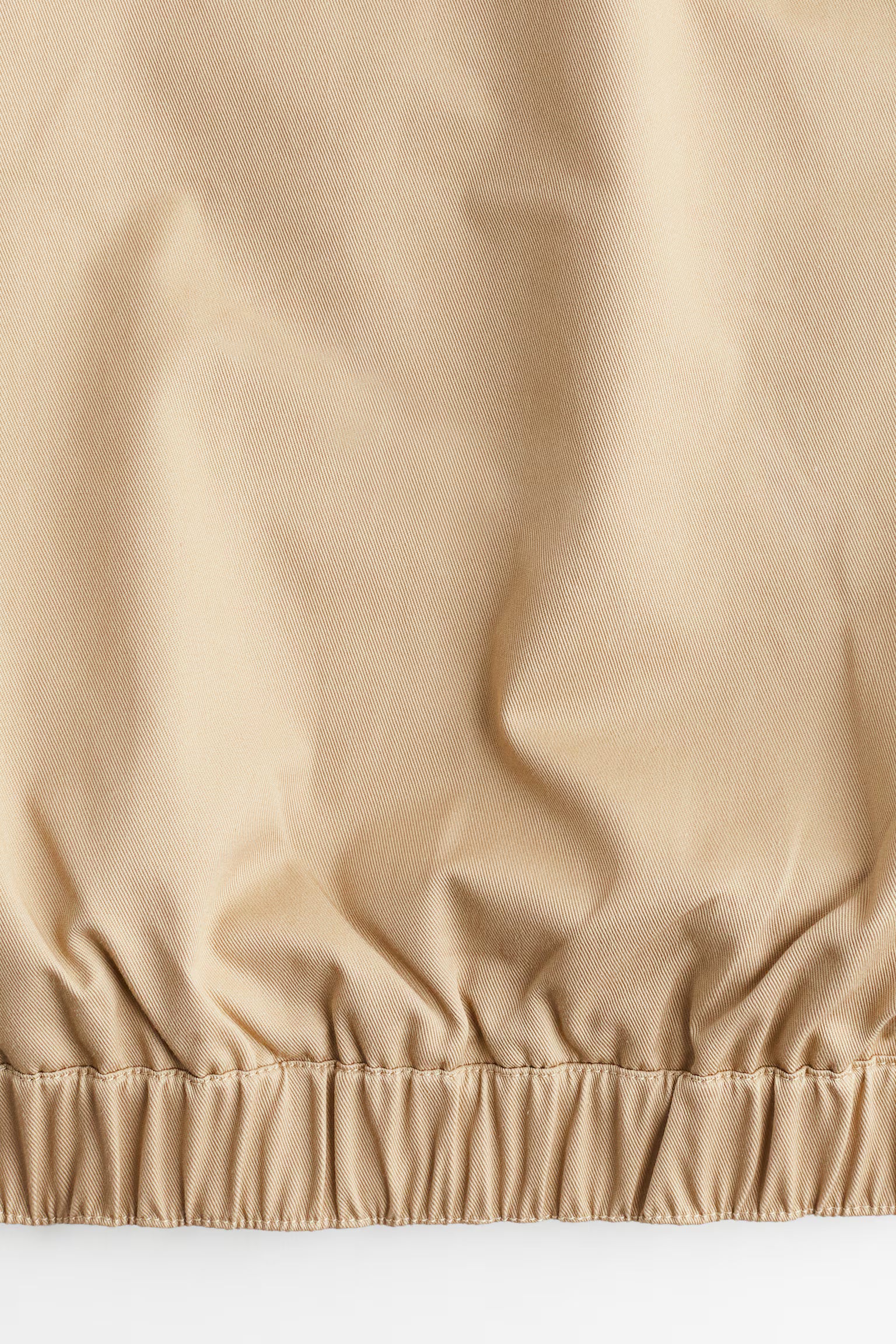 Close-up of beige fabric with a textured surface