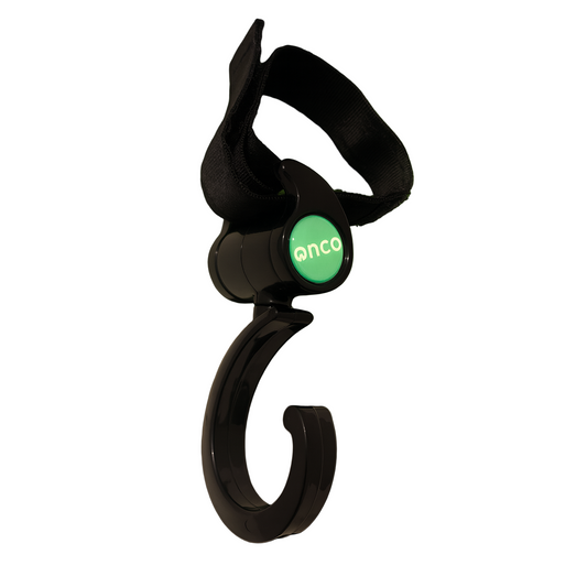 Black fishing hook with a green light on a dark background