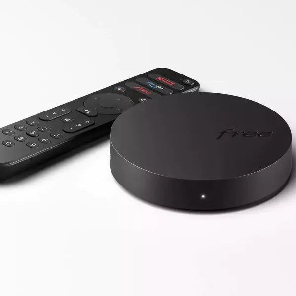 Freebox 4K TV set-top box featuring a compact black design with HDMI port, remote control, and support for Ultra HD streaming.