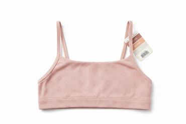 Pink sports bra with a tag on a white background