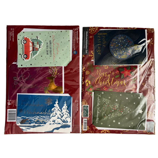 Collection of Christmas-themed greeting cards in packaging on a white background